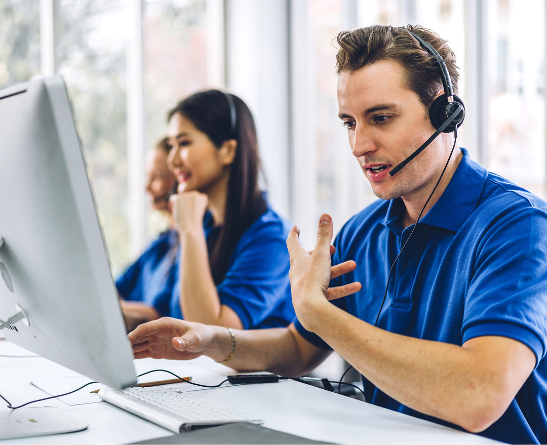 Three people working at a call centre